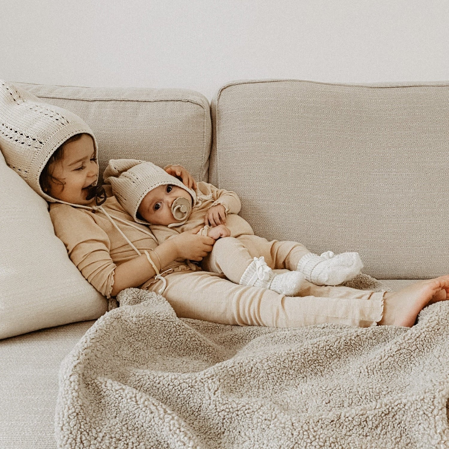 kinderen zitten op grote teddy deken. 