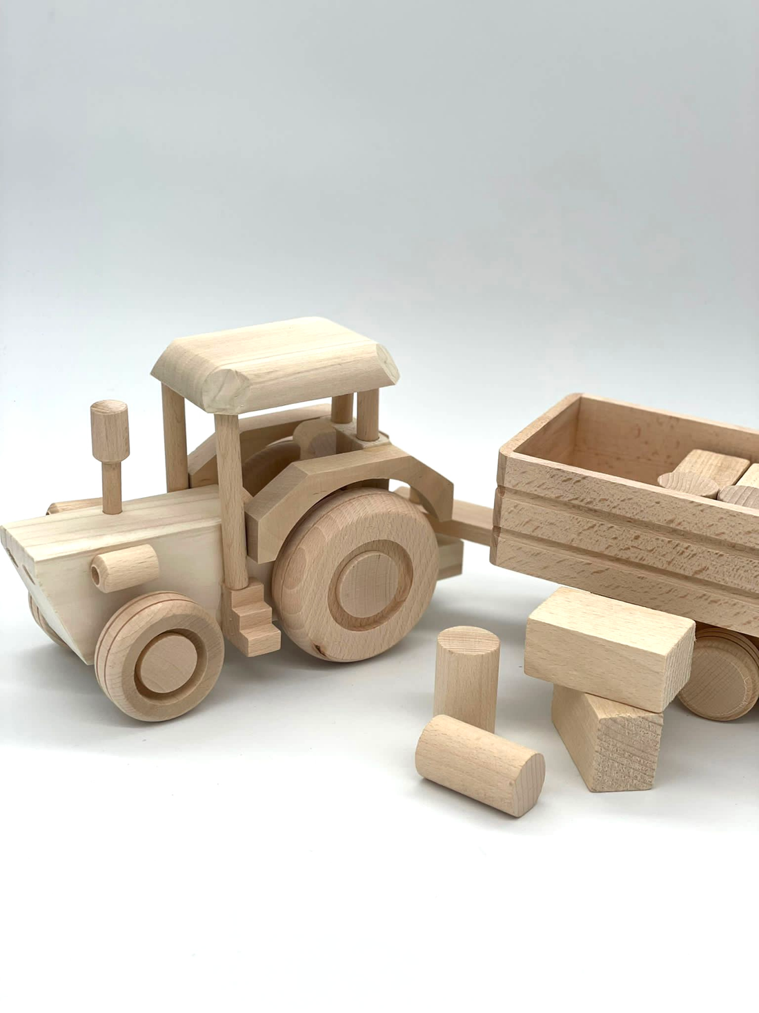 GIANT TRACTOR WITH TRAILER AND WOODEN BLOCKS