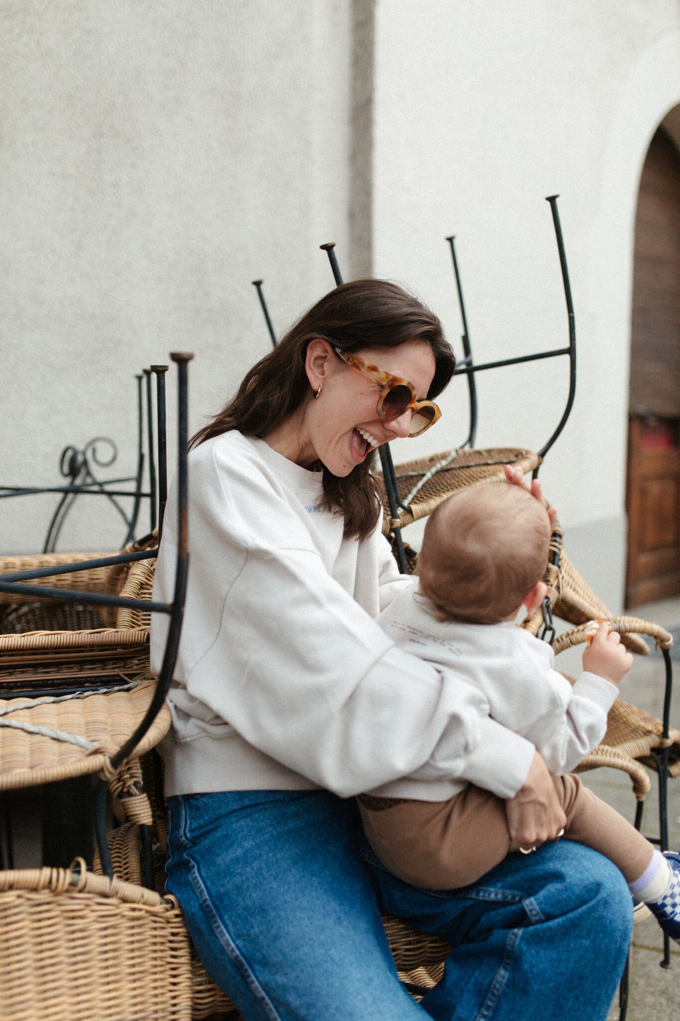 Moeder en kind in een oversized beige sweater. Gepersonaliseerd met amore in licht blauw. Gemaakt van 100% biologisch katoen.